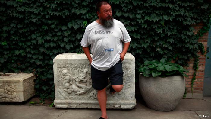 Dissident artist Ai Weiwei waits for his lawyer to return after a verdict was announced in his lawsuit against the Beijing tax authorities in Beijing Friday, July 20, 2012. A Beijing court on Friday rejected an appeal by artist Ai against a more than $2 million fine for tax evasion, which he says is part of an intimidation campaign to stop him from criticizing the government. (AP Photo/Ng Han Guan)