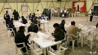 A view of a meal being served to would -be immigrants coming from Rosarno, in southern Italy's Calabria region, in the CARA (reception center for asylum seekers) in Bari (in southern Italy's Puglia region) after they abandoned their make-shift accomodations set up in former industrial sites in Rosarno, Tuesday, Jan. 12, 2010. U.N. human rights officials said Tuesday that they were deeply worried about Italy's deep-rooted racism against migrants following clashes in a southern town between African farmworkers, residents and police. Hundreds of Africans fled the farm town of Rosarno in the underdeveloped southern region of Calabria in trains, cars and caravans of buses arranged by authorities after two days of violence last week that erupted when two migrants were shot with a pellet gun in an attack they blamed on racism. (AP Photo/Donato Fasano)
