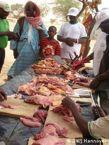 A butcher hacking up meat in
Kokorou, Niger. Picture: Jantje Hannover

