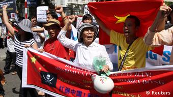 Anti China Protest Vietnam - Protesters hold banners while chanting slogans during an anti-China protest along a street in Hanoi July 22, 2012. Some hundred Vietnamese demonstrated in Hanoi on Sunday against China's moves to strengthen its claim on disputed islands in the South China Sea and its invitation to oil firms to bid for blocks in offshore areas that Vietnam claims as its territory. (Photo: Reuters)