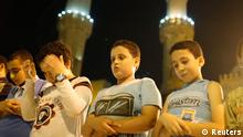 Children participate in evening prayers at a mosque in Cairo