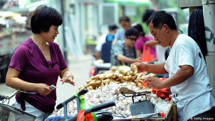 A Chinese shopper buys vegetable at a market in Beijing on July 9, 2011. China said its politically sensitive inflation rate accelerated in June to the highest level in three years, as the government struggles to rein in soaring food costs. AFP PHOTO/GOU YIGE (Photo credit should read STR/AFP/Getty Images) 