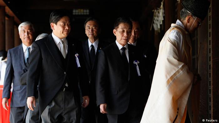 Japan's Land, Infrastructure, Transport and Tourism Minister Yuichiro Hata (2nd L) and other lawmakers are led by a Shinto priest after offering prayers to war dead at Yasukuni Shrine in Tokyo August 15, 2012, on the 67th anniversary of Japan's surrender in World War II. Japanese cabinet members paid homage at a controversial shrine for war dead on Wednesday -- the 67th anniversary of Tokyo's defeat in World War Two -- a move likely to further strain relations with China and South Korea. REUTERS/Issei Kato (JAPAN - Tags: ANNIVERSARY CONFLICT POLITICS)