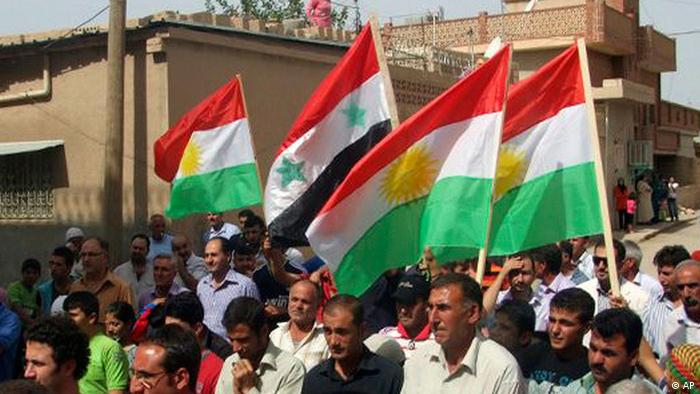 
In this citizen journalism image made on a mobile phone and provided by Shaam News Network, anti-Syrian President Bashar Assad Kurds-Syrian protesters, wave their Kurdish and Syrian flag at centre as they march during a demonstration against the Syrian regime, at the Kurds-Syrian village of Amouda, in Kamishli province, Syria, on Friday, Sept. 30, 2011. 
Photo:Shaam News Network/AP/dapd)
