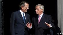 Greek Prime Minister Antonis Samaras, left, welcomes Jean Claude Junker, Prime Minister, of Luxembourg and President of Eurogroup prior their meeting in Athens, on Wendesday, Aug. 22, 2012. 