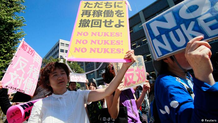 Anti-nuclear protesters hold a rally outside Japan's Prime Minster Yoshihiko Noda's official residence in Tokyo August 22, 2012. Noda met representatives of a growing anti-nuclear energy movement on Wednesday amid signs his government, pressured by public safety fears, might be leaning towards a target to eliminate atomic power within two decades.The characters on the poster reads, "Must cancel the decision to restart (the nuclear reactors) immediately." REUTERS/Yuriko Nakao (JAPAN - Tags: POLITICS ENERGY CIVIL UNREST)