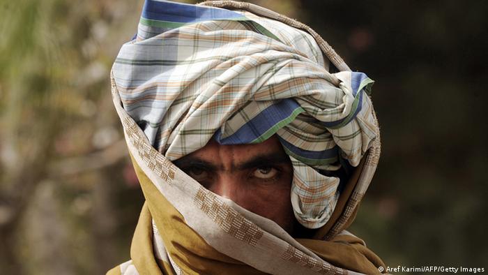 A former Taliban fighter looks on after joining Afghan government forces during a ceremony in Herat province on March 26, 2012. (Photo: AFP)