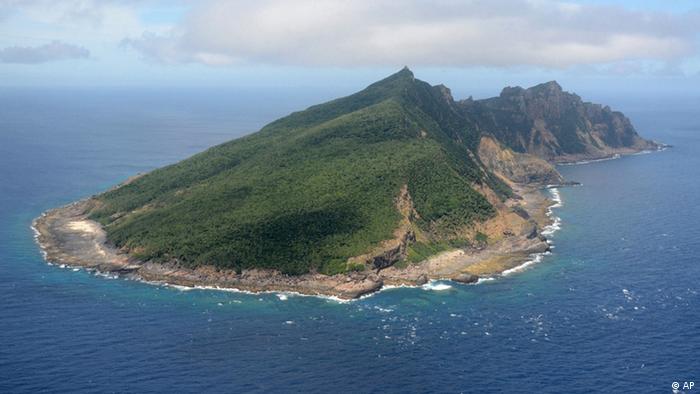 FILE - This June 2011 file photo shows Uotsuri Island, one of the islands of Senkaku in Japanese and Diaoyu in Chinese, in the East China Sea. Tokyo officials are set to head by boat Saturday night, Sept. 1, 2012 to the tiny islands controlled by Japan but claimed by China and Taiwan to carry out a survey before buying the islands, heating up a longtime territorial dispute. Tokyo Gov. Shintaro Ishihara has already raised 1.45 billion yen ($19 million) in donations to buy the islands from Japanese owners. (AP Photo/Kyodo News) JAPAN OUT, MANDATORY CREDIT, NO LICENSING IN CHINA, HONG KONG, JAPAN, SOUTH KOREA AND FRANCE