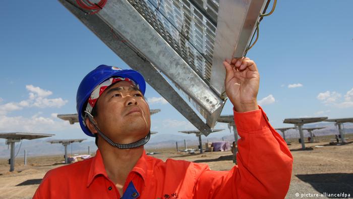 Chinese workers check and test solar panels at Fuguang photovoltaic power station in Hami city, northwest Chinas Xinjiang Uygur Autonomous Region, 6 August 2012. China, the biggest supplier of solar power panels, quadrupled a domestic installation goal for solar energy projects to 21 gigawatts by 2015 to help absorb the excess supply of panels and support prices. The target includes 1 gigawatt of solar-thermal power plants, said Shi Lishan, deputy director of the administrations renewable energy division. China had planned 5 gigawatts of capacity in the five years through 2015 and 20 gigawatts by 2020. 