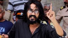 Indian political cartoonist Aseem Trivedi gestures after he is arrested by the police on charges of mocking the Indian constitution in his drawings, in Mumbai, India, Sunday, Sept. 9, 2012 (Photo: AP)