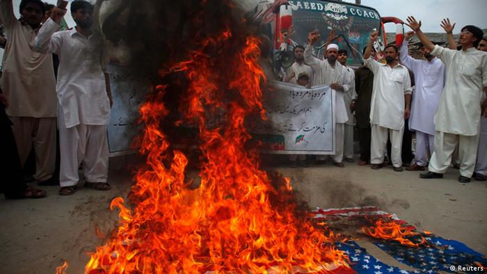 Shite Muslim supporters of the Imamia Student Organization (ISO) shout slogans as they burn a U.S. flag during an anti-American demonstration in Peshawar September 14, 2012. Some 40 protesters gathered to take part in the protest to condemn a film being produced in the U.S. that insulted Prophet Mohammad.
REUTERS/Fayaz Aziz     (PAKISTAN - Tags: POLITICS CIVIL UNREST RELIGION)
