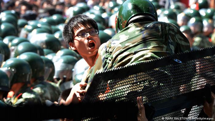 A man tries to climb over police lines during an anti-Japanese protest over the Diaoyu islands issue, known as the Senkaku islands in Japanese, outside the Japanese Embassy in Beijing on September 15, 2012.