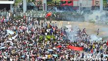 epa03399644 Riot police fire tear gas at protesters outside the city headquarters of Communist Party of China during an anti-Japan protest in Shenzhen in south China's Guangdong province 16 September 2012. Protests across several Chinese cities continued, in the country's ongoing row with Japan over disputed islands in the South China Sea. In the capital, Beijing, several thousand people, mostly young, carried Chinese flags and images of Mao in front of the Japanese embassy. Police were seen in heavy numbers. The demonstrators called on Japan to withdraw from the islands. The dispute between the two countries escalated on Friday when six Chinese ships began patrolling the waters around the islands. EPA/LAN QING CHINA OUT
