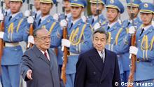 Chinese President Yang Shangkun (L) and Japanese Emperor Akihito review the honor guard in front of the Great Hall of the People in Beijing, 23 October 1992. Akihito arrived in China 23 October 1992, to mark the 20th anniversary of Sino-Japanese diplomatic relations. (Photo credit should read MIKE FIALA/AFP/GettyImages) 