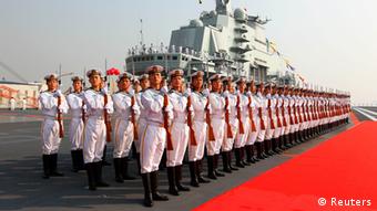 Naval honour guards stand as they wait for a review on China's aircraft carrier Liaoning in Dalian, Liaoning province, September 25, 2012. China's first aircraft carrier was delivered and commissioned to the Navy of the Chinese People's Liberation Army on Tuesday after years of refitting and sea trials. REUTERS/Xinhua/Zha Chunming (CHINA - Tags: MILITARY POLITICS) NO SALES. NO ARCHIVES. FOR EDITORIAL USE ONLY. NOT FOR SALE FOR MARKETING OR ADVERTISING CAMPAIGNS. THIS IMAGE HAS BEEN SUPPLIED BY A THIRD PARTY. IT IS DISTRIBUTED, EXACTLY AS RECEIVED BY REUTERS, AS A SERVICE TO CLIENTS. CHINA OUT. NO COMMERCIAL OR EDITORIAL SALES IN CHINA. YES
