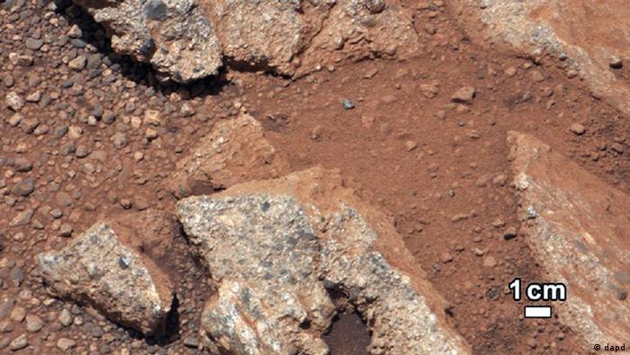 This image provided by NASA shows shows a Martian rock outcrop near the landing site of the rover Curiosity thought to be the site of an ancient streambed. Curiosity landed in a crater near Mars' equator on Aug. 5, 2012, on a two-year mission to study whether the environment could have been favorable for microbial life. (AP Photo/NASA)