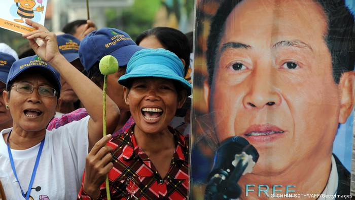 Cambodian protesters shout slogans next to a portrait of Mam Sonando (R), owner of the independent Beehive radio station, during a rally near the Phnom Penh municipal court on October 1, 2012. Photo: TANG CHHIN SOTHY/AFP/GettyImages