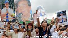 Supporters shout slogans as they hold up portraits of detained radio station owner Mam Sonando during a protest near the Phnom Penh municipal court on October 1, 2012. Photo: TANG CHHIN SOTHY/AFP/GettyImages