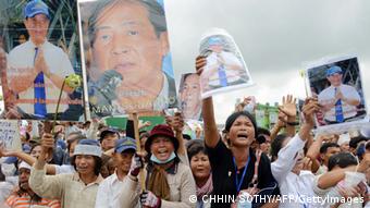 Supporters shout slogans as they hold up portraits of detained radio station owner Mam Sonando during a protest near the Phnom Penh municipal court on October 1, 2012. (Photo: TANG CHHIN SOTHY/AFP/GettyImages)