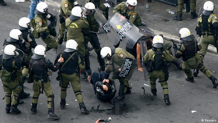 Greek demonstrators are arrested by riot policemen 
Photo: REUTERS/Grigoris Siamidis
