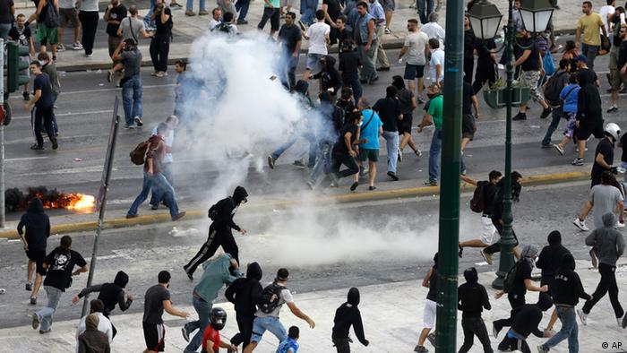 Protesters run away from tear gas during clashes in front of the parliament in Athens on Tuesday Oct. 9, 2012.
Photo:Dimitri Messinis/AP/dapd