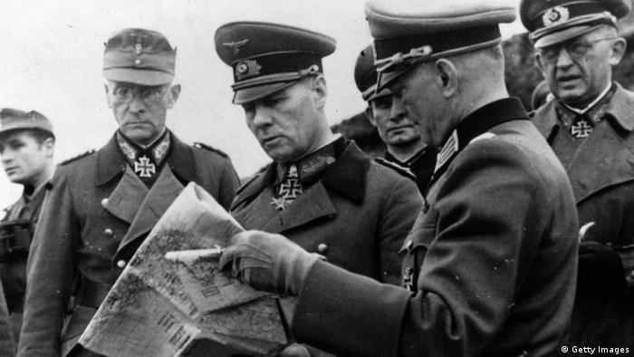 Field Marshal Erwin Rommel (1891 - 1944), centre, studies a map with other German army officers at Caen, France, during an inspection tour of coastal defences. (Photo by Keystone/Getty Images)