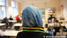 A girl in a headscarf takes part in a school class
Photo: Bernd Thissen