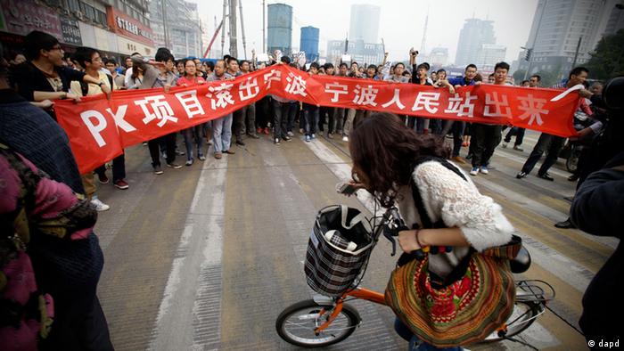 Protesters march with a banner which reads Project PX get out of Ningbo, Ningbo people stand up in Zhejiang province's Ningbo city, protesting the proposed expansion of a petrochemical factory Sunday, Oct. 28, 2012. Thousands of people in the eastern Chinese city clashed with police Saturday while protesting the proposed expansion of the factory that they say would spew pollution and damage public health, townspeople said. (AP Photo/Ng Han Guan)