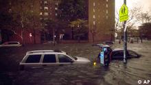 Vehicles are submerged on 14th Street near the Consolidated Edison power plant, Monday, Oct. 29, 2012, in New York. Sandy continued on its path Monday, as the storm forced the shutdown of mass transit, schools and financial markets, sending coastal residents fleeing, and threatening a dangerous mix of high winds and soaking rain.  (AP Photo/ John Minchillo)