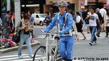 A police officer patrol at the Ginza shopping district in Tokyo TOSHIFUMI KITAMURA/AFP/GettyImages