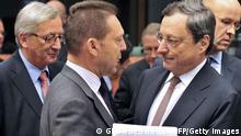 Luxembourg's Prime Minister and Eurogroup president Jean-Claude Juncker, Greek Finance Minister Yannis Stournaras and Italian President of the Financial Stability Board and Governor of the Bank of Italy Mario Draghi speek prior an Eurozone meeting on November 12, 2012 at the EU Headquarters in Brussels. Greece's unrelenting debt drama tops the agenda Monday when Eurozone finance ministers discuss whether Athens has met conditions set by its international creditors to provide nailout funds so it can stay afloat. AFP PHOTO GEORGES GOBET (Photo credit should read GEORGES GOBET/AFP/Getty Images)