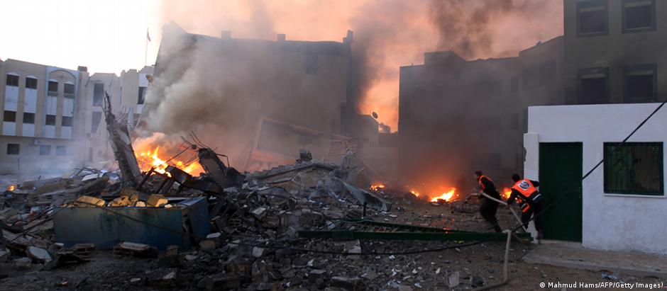 Palestinians extinguish a fire after Israeli air strikes targeted Interior Ministry building in Gaza City, on November 16, 2012 . AFP PHOTO/MAHMUD HAMS (Photo credit should read MAHMUD HAMS/AFP/Getty Images) 