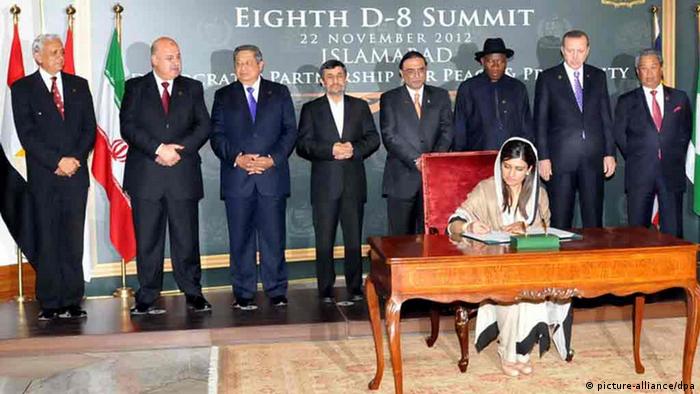 Pakistani Foreign Minister Hina Rabbani Khar signing the Developing Eight (D-8) Charter while D-8 leaders look on
(Photo: EPA/PID / HANDOUT HANDOUT EDITORIAL USE ONLY/NO SALES)