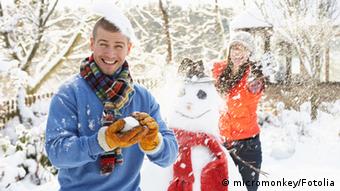 Young Couple Having Snowball Fight In Garden © micromonkey #22562697
