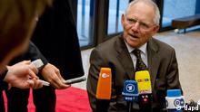 German Finance Minister Wolfgang Schaeuble, center, speaks with the media as he arrives for a meeting of eurogroup finance ministers in Brussels on Monday, Nov. 26, 2012. Eurozone finance ministers are set to meet in Brussels on Monday to discuss the next installment of bailout money for debt-laden Greece. (AP Photo/Virginia Mayo