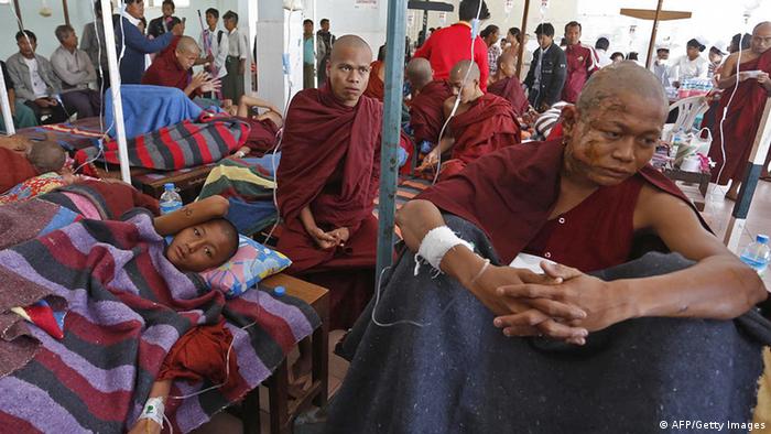 A severely burnt Buddhist monk (C) receives treatment at a hospital after police fired water cannon and gas during a pre-dawn crackdown on villagers and monks protesting against a Chinese-backed copper mine, in Monywa northern Myanmar on November 29, 2012. Dozens were injured, activists said, when police broke up the demonstration which is the latest example of long-oppressed Myanmar citizens testing the limits of their new freedoms after the end last year of decades of authoritarian junta rule that saw protests routinely stamped out. AFP PHOTO / J MAUNG MAUNG (Photo credit should read AFP/AFP/Getty Images)