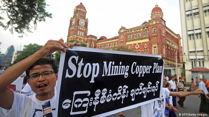 Protesters hold banners as they protest against Latpadaung copper mining plan in Yangon on November 26, 2012. The copper mine, a joint venture between military-owned Myanmar Economic Holdings and China's Wanbao company, has been the subject of controversy for months after local media allegations of corruption over the project. AFP PHOTO/ Soe Than WIN (Photo credit should read Soe Than WIN/AFP/Getty Images)