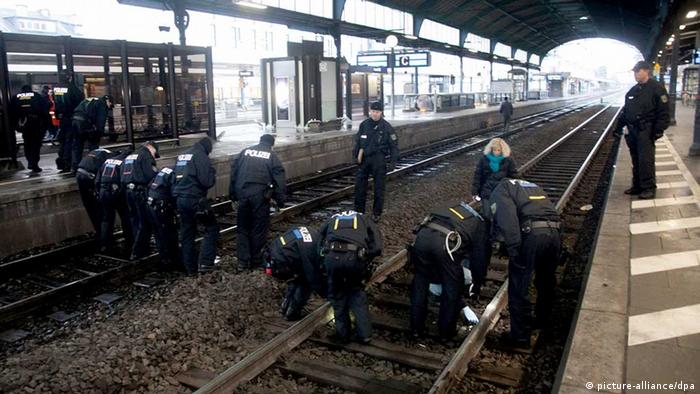 Police check the tracks at the Bonn train station after the bag with the bomb was found

