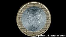 Image of a euro coin with the image of Angela Merkel