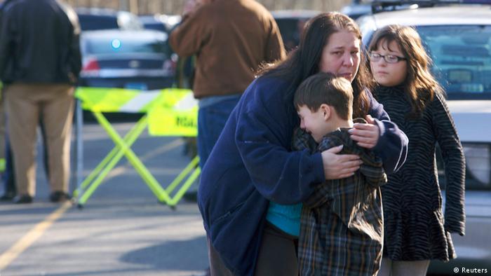 A young boy is comforted outside Sandy Hook Elementary School after a shooting in Newtown, Connecticut, December 14, 2012. A shooter opened fire at the elementary school in Newtown, Connecticut, on Friday, killing several people including children, the Hartford Courant newspaper reported. REUTERS/Michelle McLoughlin (UNITED STATES - Tags: CRIME LAW EDUCATION TPX IMAGES OF THE DAY)