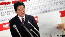 Japan's main opposition Liberal Democratic Party leader Shinzo Abe answers a reporter's question at the party headquarters in Tokyo, Sunday night, Dec. 16, 2012