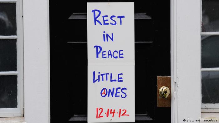 A sign reading Rest in Peace Little Ones' hangs on the front door of a house in Newtown, Connecticut
(EPA/Peter Foley/dpa)