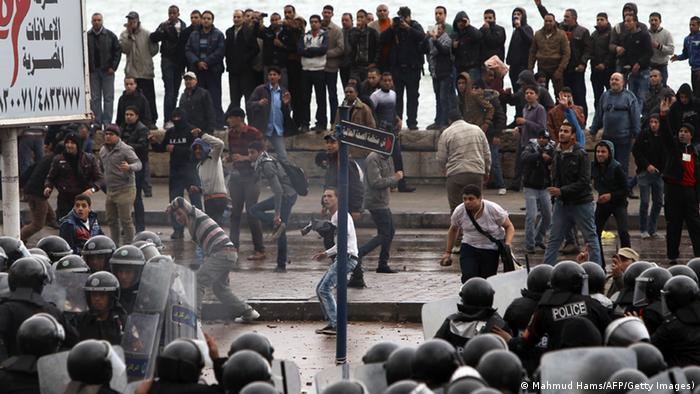 Egyptian riot police try to quell clashes between opponents and supporters of President Mohamed Morsi in the Mediterranean coastal city of Alexandria on December 21, 2012. MAHMUD HAMS/AFP/Getty Images