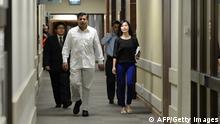 India's high commissioner to Singapore T.C.A Raghavan (2ndL) walks along the corridor to speak to journalists at the Mount Elizabeth hospital after the announcement of the death of the Indian gang-rape victim, in Singapore on December 29, 2012. The victim, 23, died Saturday in Singapore after suffering severe organ failure, the hospital treating her said, in a case that sparked widespread street protests over violence against women. AFP PHOTO/ROSLAN RAHMAN (Photo credit should read ROSLAN RAHMAN/AFP/Getty Images)