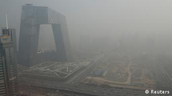 The China Central Television (CCTV) building is seen next to a construction site in heavy haze in Beijing's central business district, January 14, 2013. In an unusual display of unity in criticising a troubling domestic social problem, Chinese media are giving prominent coverage to the historically high level of air pollution that has choked wide swaths of the country for the past few days. Air quality in Beijing was far above hazardous levels over the weekend, reaching 755 or higher, according to an index known as PM2.5. The World Health Organisation recommends a daily level of no more than 20 for PM2.5, which measures particulate matter with a diameter of 2.5 micrometers. REUTERS/Jason Lee (CHINA - Tags: ENVIRONMENT BUSINESS MEDIA)