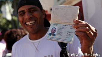 A man shows his passport as he leaves immigration offices in Havana, Cuba
Alejandro Ernesto/EPA/dpa 