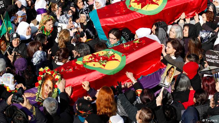 People carry the coffins of the Kurdish activists who were shot in Paris, during a funeral ceremony in Diyarbakir, the largest city in Turkey's mainly Kurdish southeast, January 17, 2013. The bodies of the three activists, including that of Kurdistan Workers Party (PKK) co-founder Sakine Cansiz, arrived by plane on Wednesday evening in Diyarbakir. REUTERS/Umit Bektas (TURKEY - Tags: POLITICS OBITUARY CIVIL UNREST)