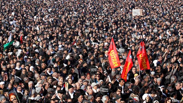 Thousands attend the funeral ceremony of the three Kurdish activists shot in Paris, in Diyarbakir, the largest city in Turkey's mainly Kurdish southeast, January 17, 2013. The bodies of the activists, including that of Kurdistan Workers Party (PKK) co-founder Sakine Cansiz, arrived by plane on Wednesday evening in Diyarbakir. REUTERS/Umit Bektas (TURKEY - Tags: POLITICS OBITUARY CIVIL UNREST)