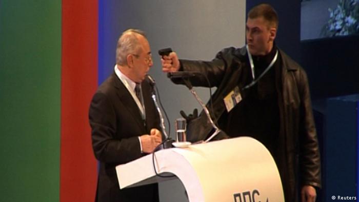 An unidentified man (R) attacks Ahmed Dogan, leader of Bulgaria's Movement for Rights and Freedom (MRF) party, as he delivers his speech during his party's annual conference at the National Palace of Culture in Sofia in this still image taken from video footage on January 19, 2013. Dogan was attacked by a man carrying a gun during his speech at the party conference in Sofia on Saturday. The attacker was later arrested and Dogan escaped unhurt . REUTERS/Nikola Stoyanov/Bnews 