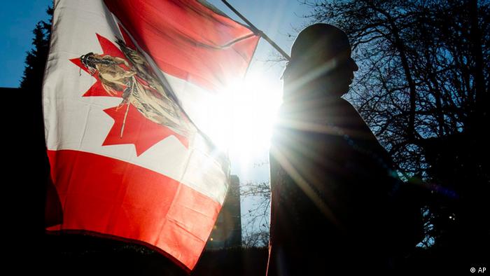 Man waving Canadian flag . (Photo: Jonathan Hayward)
